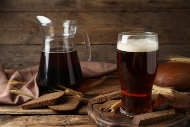 Composition with delicious kvass, spikes and bread on wooden table