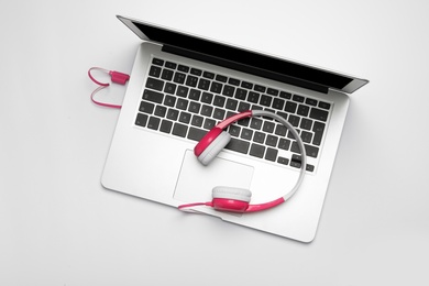 Photo of Modern headphones and laptop on white background, top view