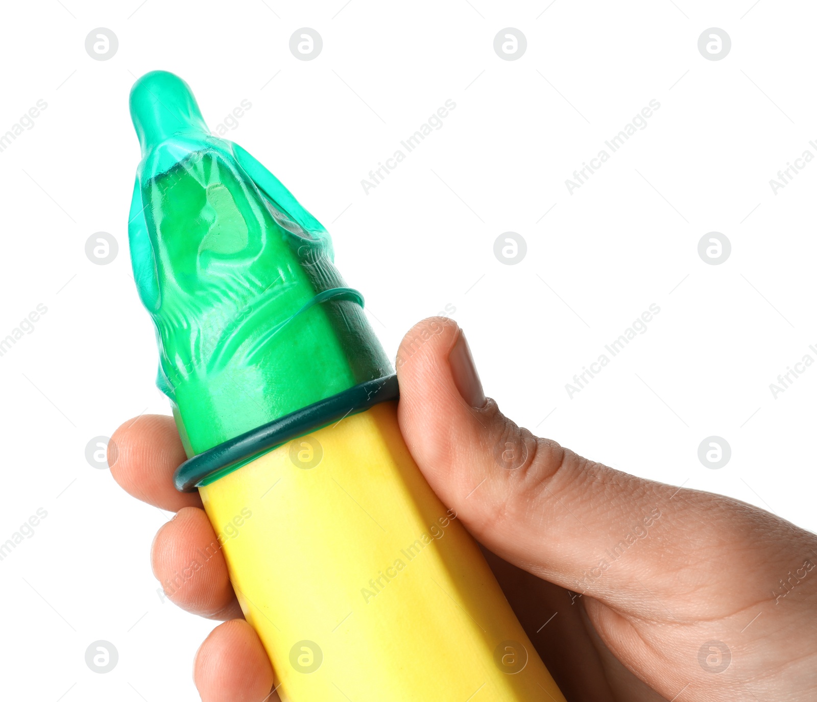 Photo of Woman holding banana in condom on white background, closeup. Safe sex concept
