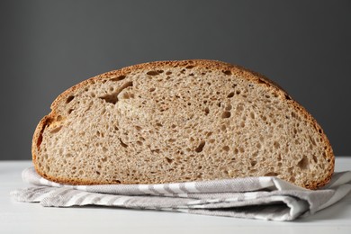 Photo of Freshly baked cut sourdough bread on white table