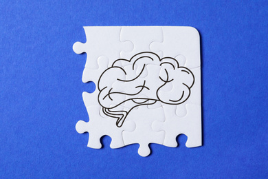 Image of Idea concept. White puzzle pieces on blue background, top view