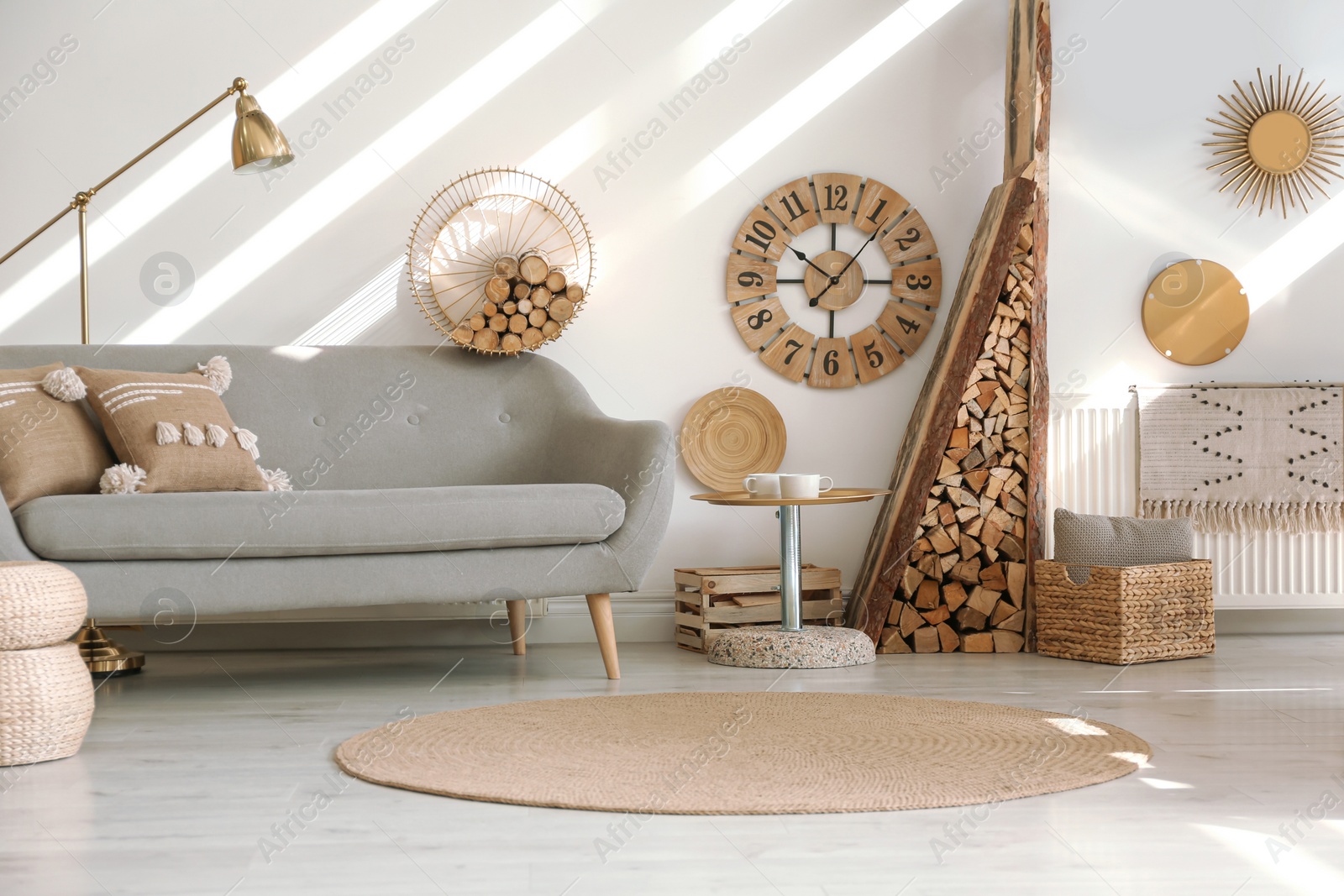 Photo of Stylish room interior with firewood as decorative element