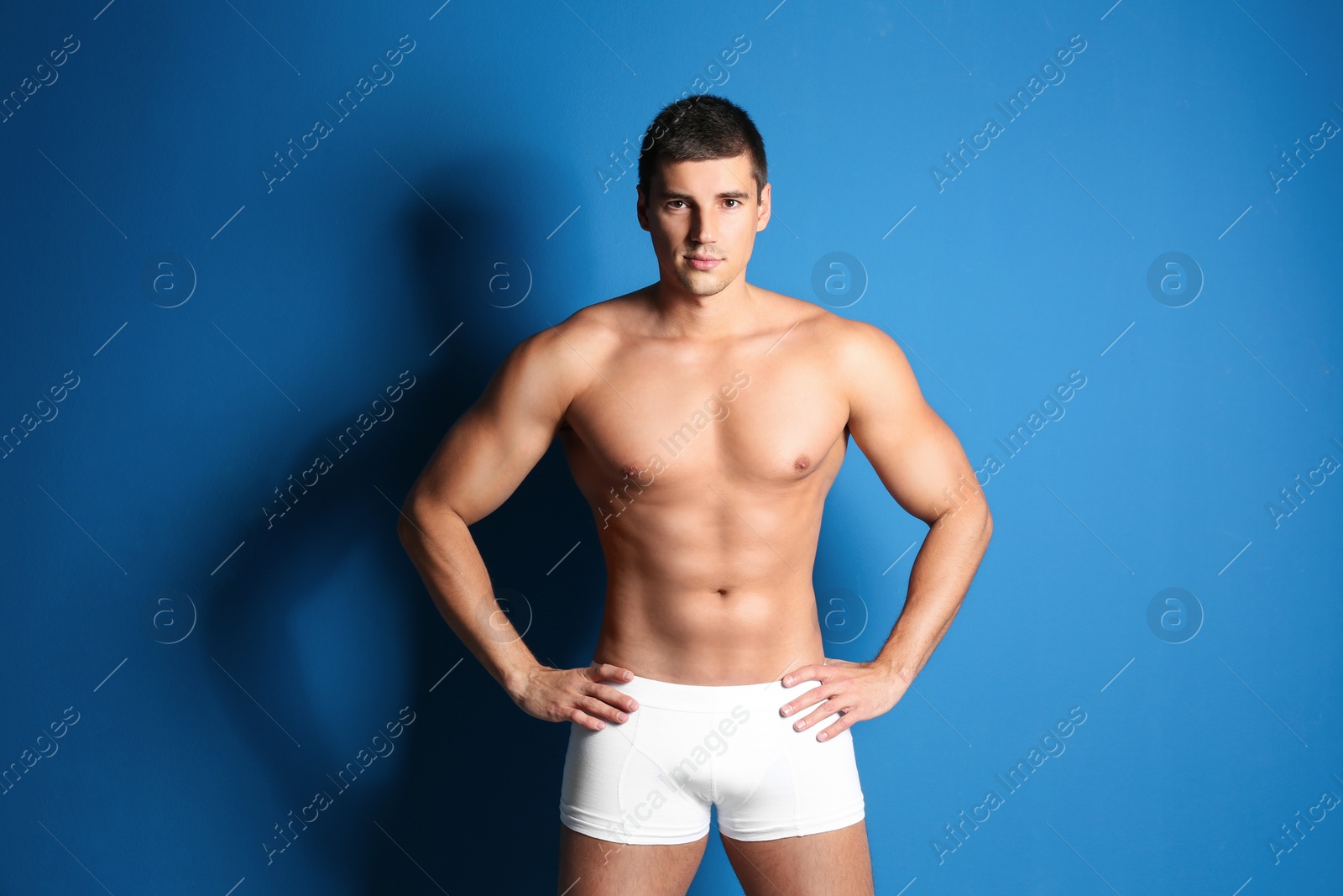 Photo of Man with sexy body on blue background