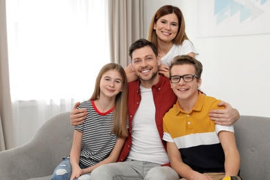 Happy parents with their teenager children at home