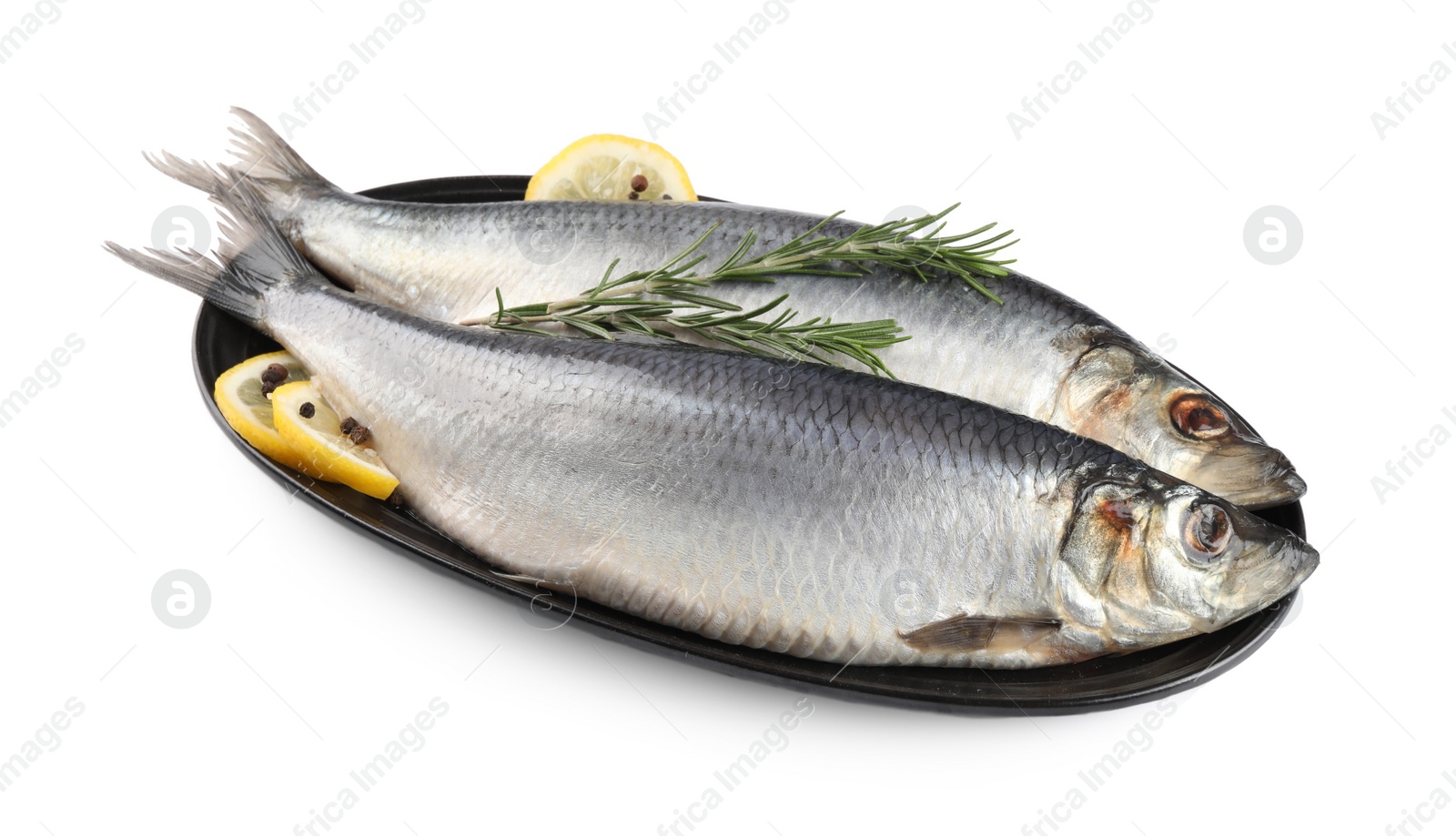 Photo of Plate with salted herrings, slices of lemon, peppercorns and rosemary isolated on white