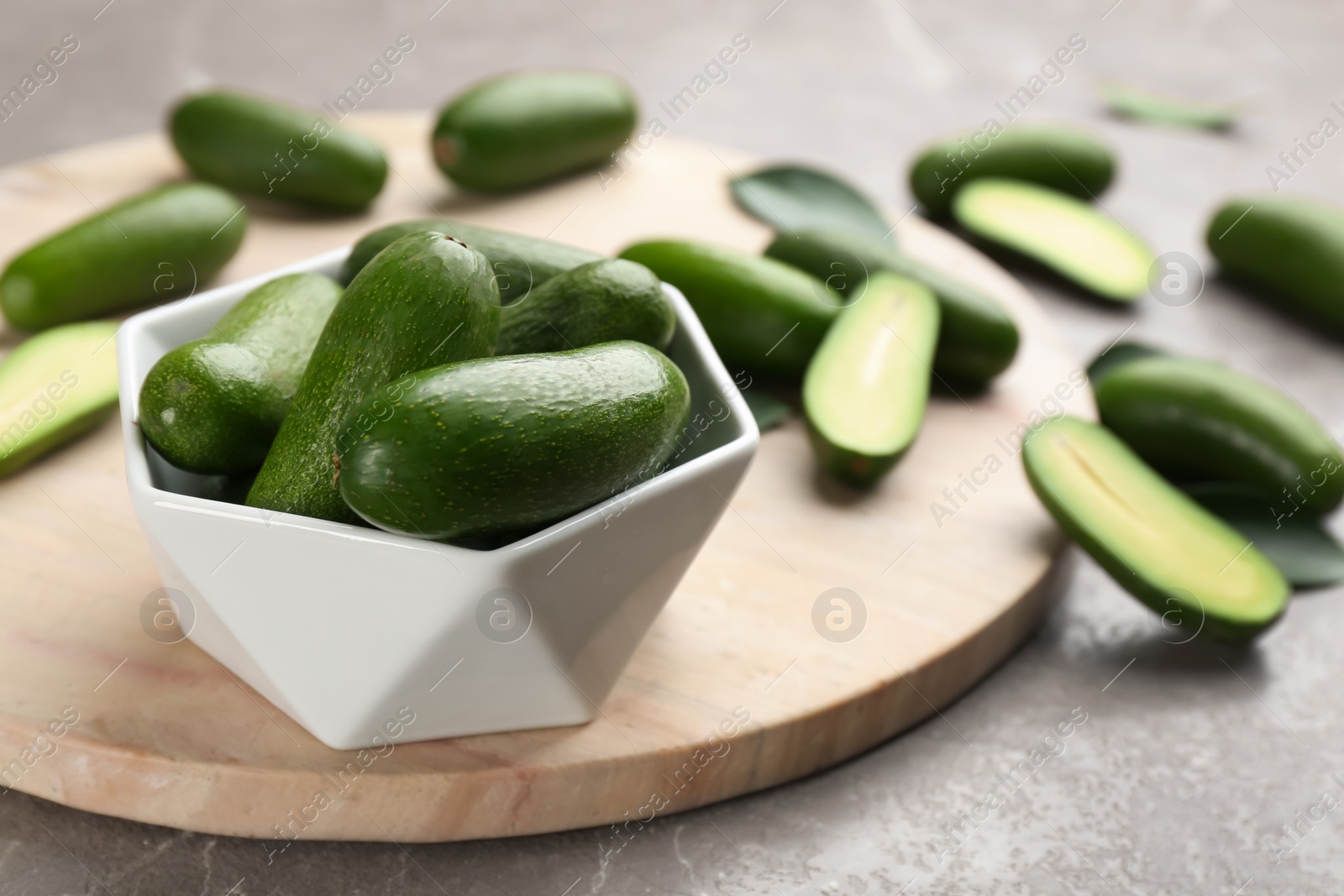 Photo of Fresh seedless avocados on grey table, closeup. Space for text