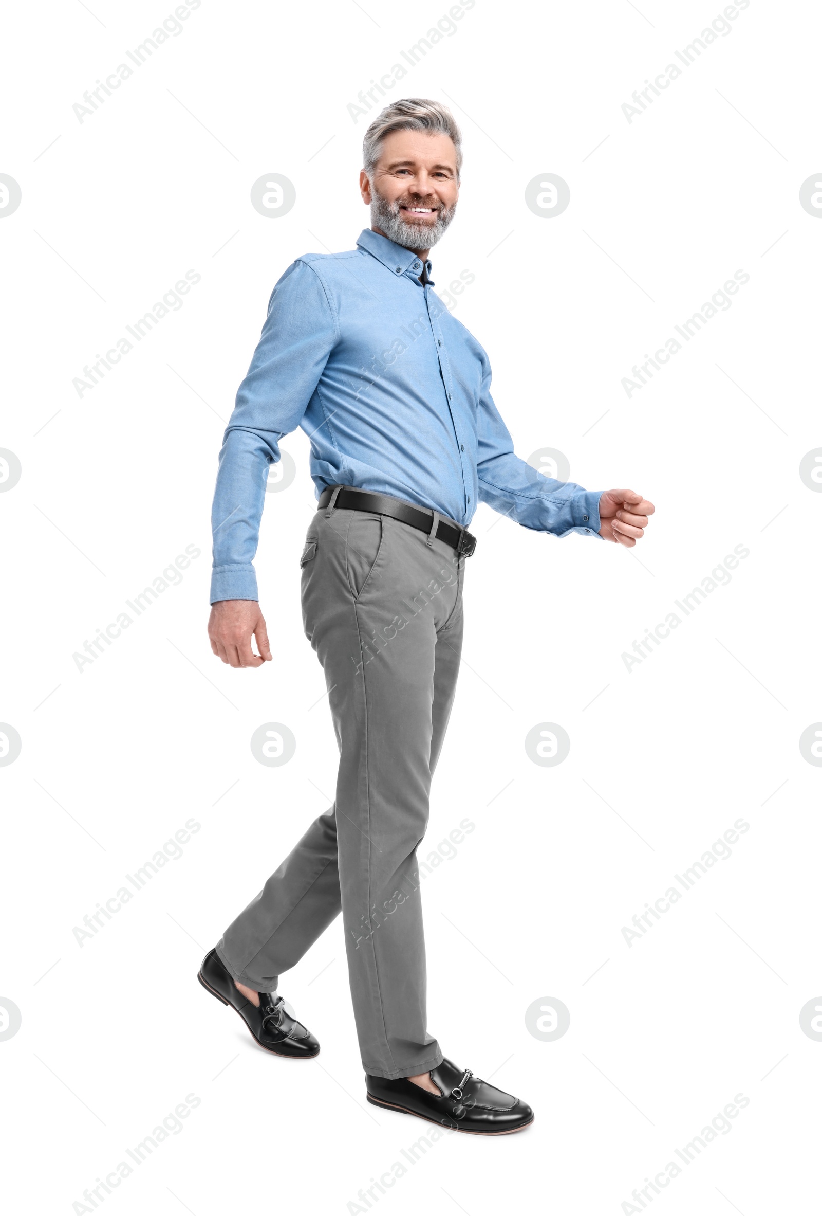 Photo of Mature businessman in stylish clothes posing on white background, low angle view