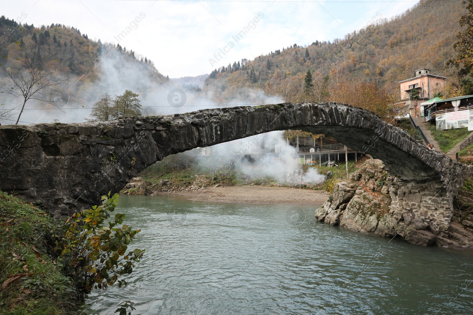 Photo of Adjara, Georgia - November 19, 2022: Picturesque view of stone arched bridge over Acharistskali river in mountains