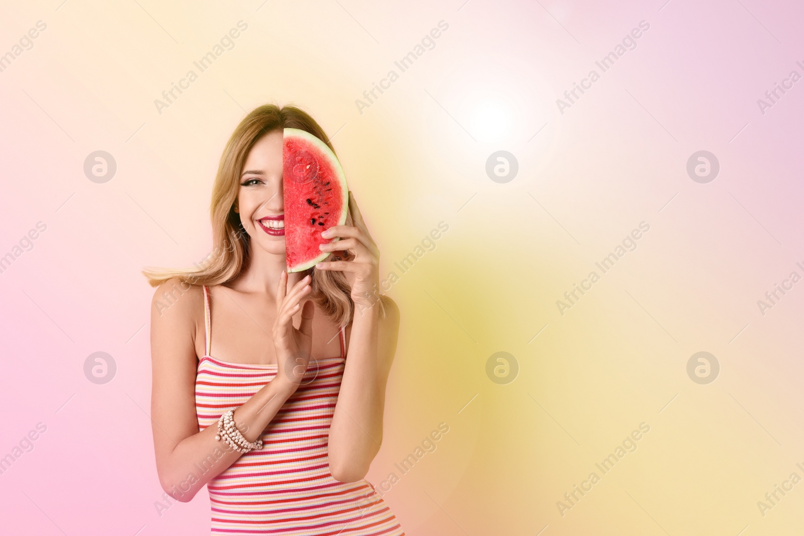 Image of Pretty young woman with juicy watermelon on color background, space for text. Summer party