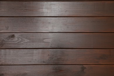 Photo of Texture of dark wooden surface as background, top view