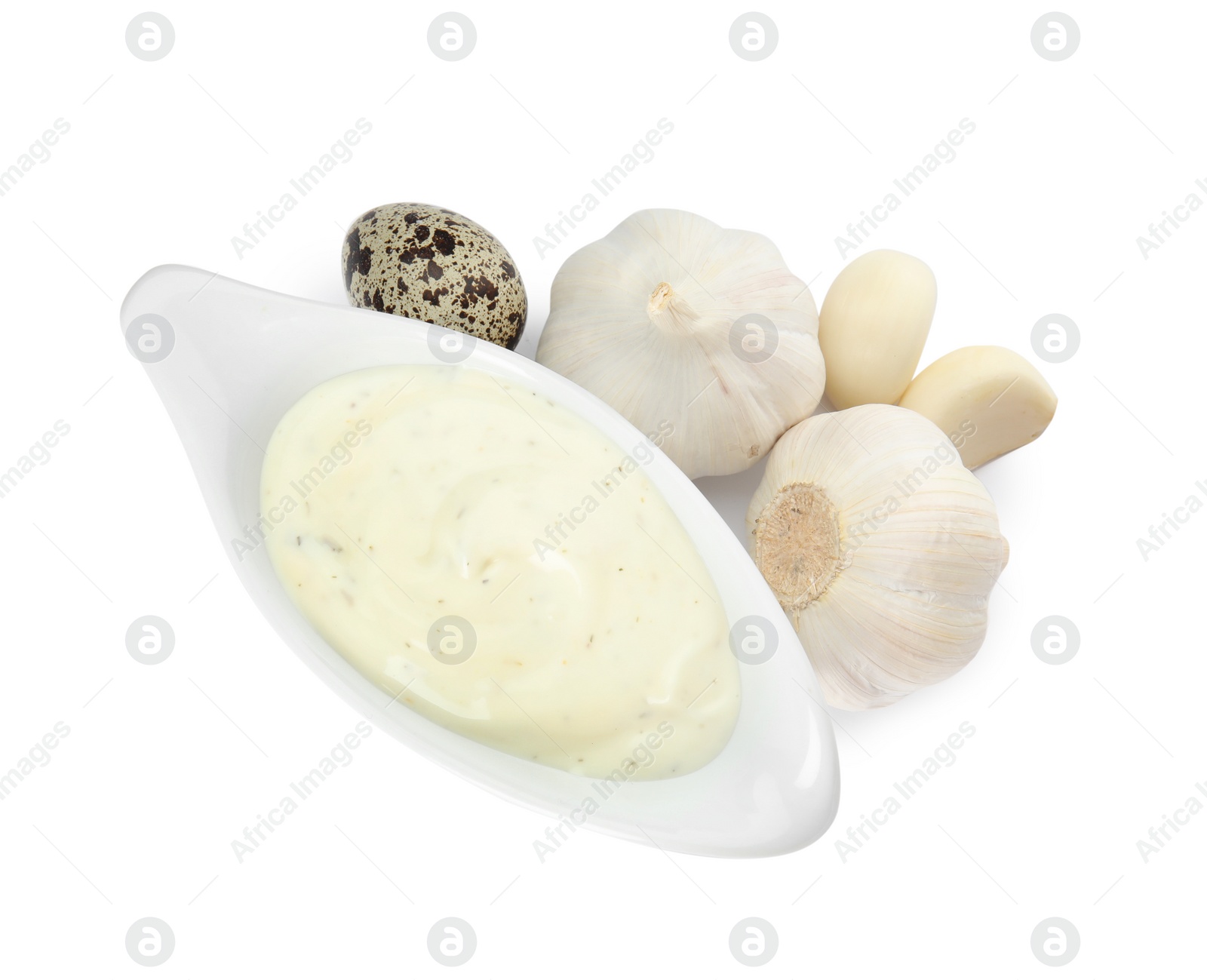 Photo of Gravy boat of sauce, garlic and quail egg isolated on white, top view