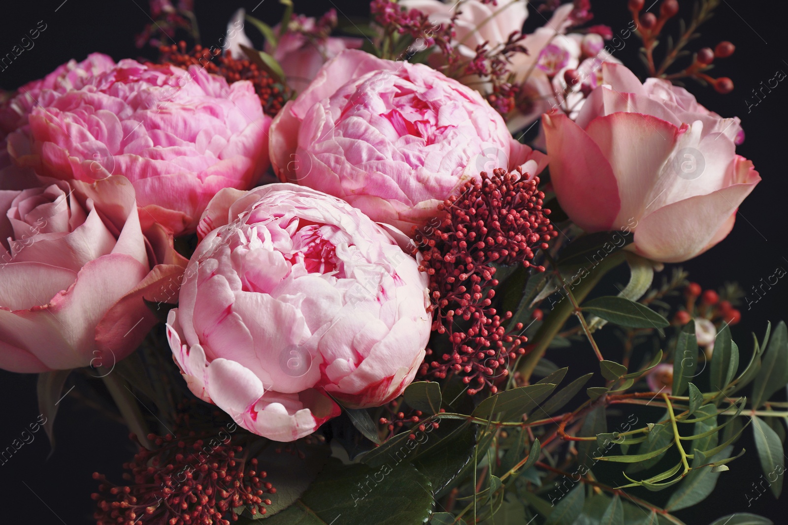 Photo of Beautiful fresh bouquet on dark background, closeup. Floral decor