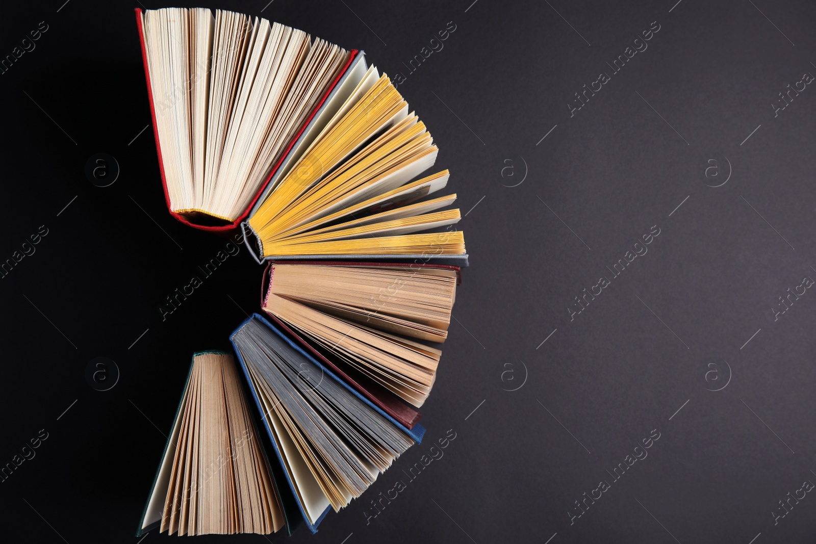 Photo of Hardcover books on black background, flat lay. Space for text