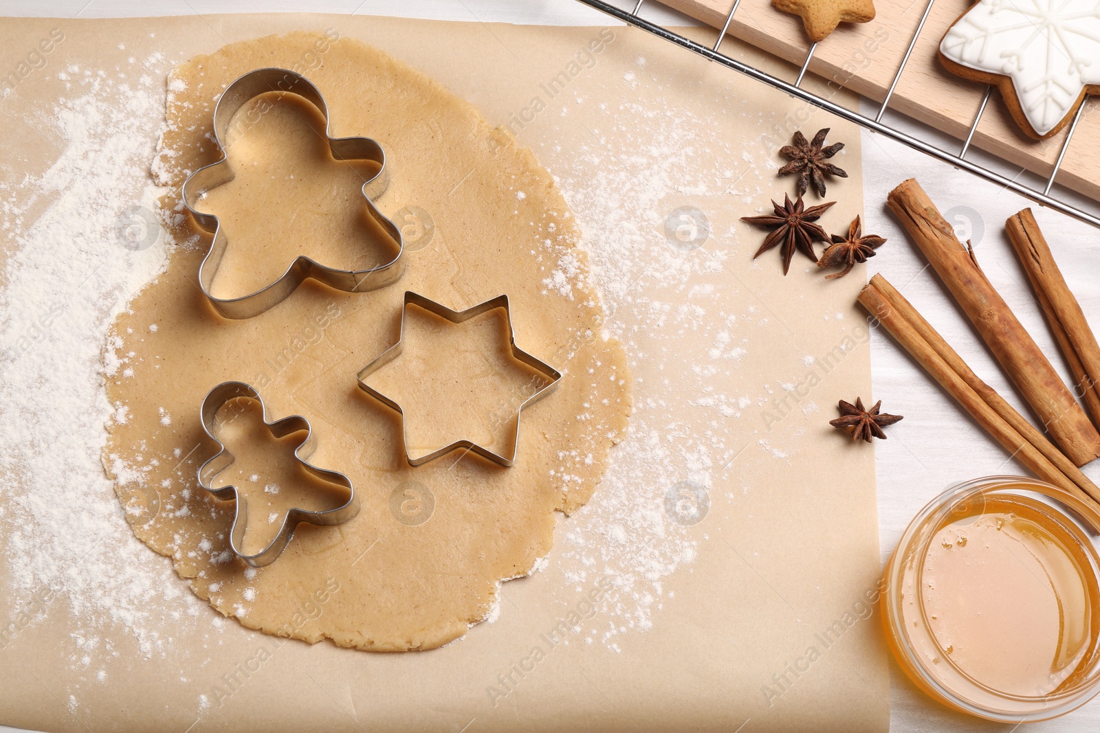 Photo of Making Christmas cookies. Flat lay composition with ingredients and raw dough on white table