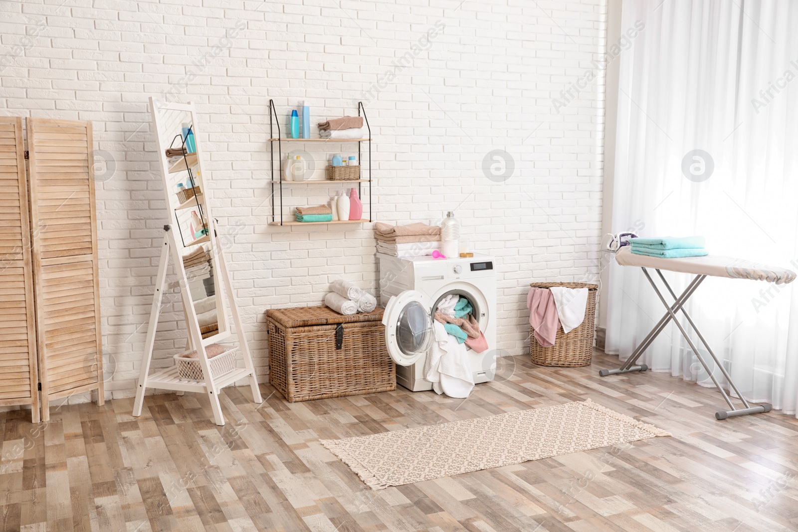 Photo of Bathroom interior with dirty towels in washing machine