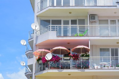 Photo of Exterior of residential building with balconies against blue sky