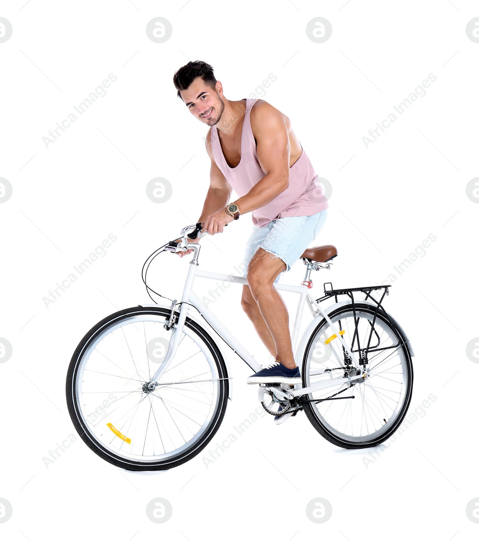 Photo of Handsome young hipster man riding bicycle on white background