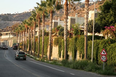 Photo of Beautiful view of highway with cars and palm trees in city