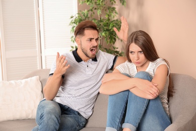 Young couple arguing in living room. Relationship problems