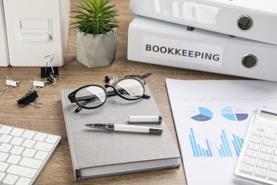 Photo of Bookkeeper's workplace with folders and documents on table