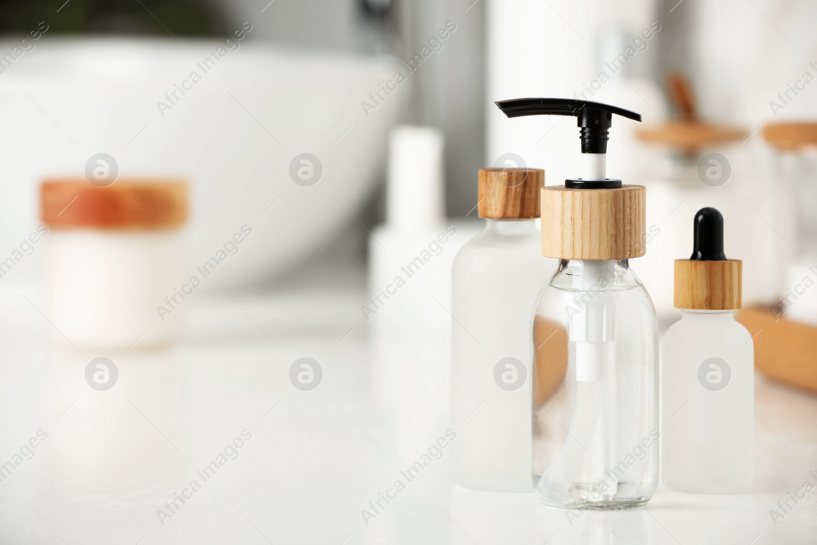 Photo of Different personal care products on countertop in bathroom. Space for text