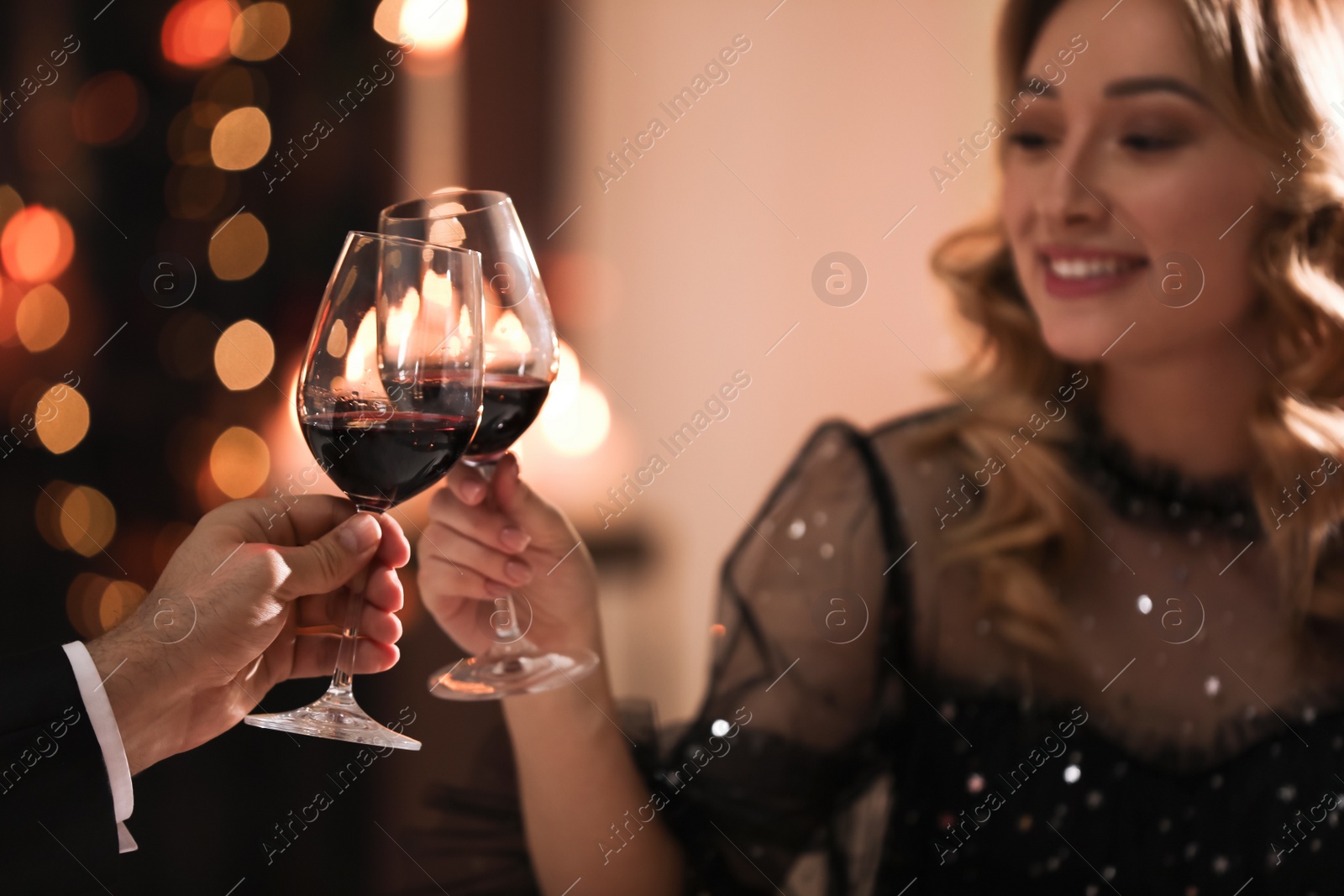 Photo of Lovely couple clinking glasses at Valentine's day dinner in restaurant
