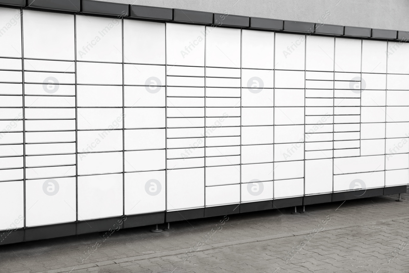 Photo of Modern parcel locker with many postal boxes outdoors