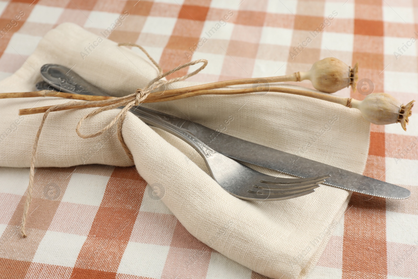 Photo of Stylish setting with cutlery and napkin on table, closeup