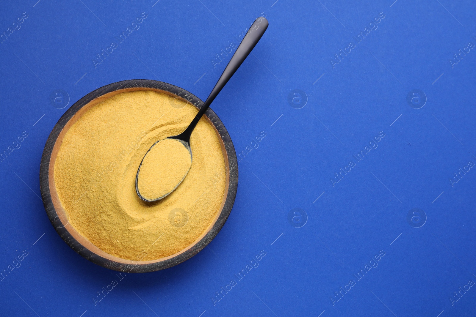 Photo of Beer yeast pills on blue background, top view. Space for text