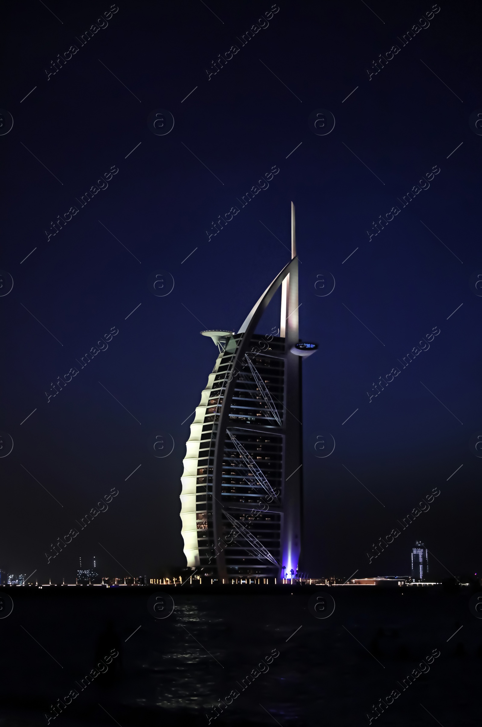 Photo of DUBAI, UNITED ARAB EMIRATES - NOVEMBER 03, 2018: Night landscape with illuminated Burj Al Arab