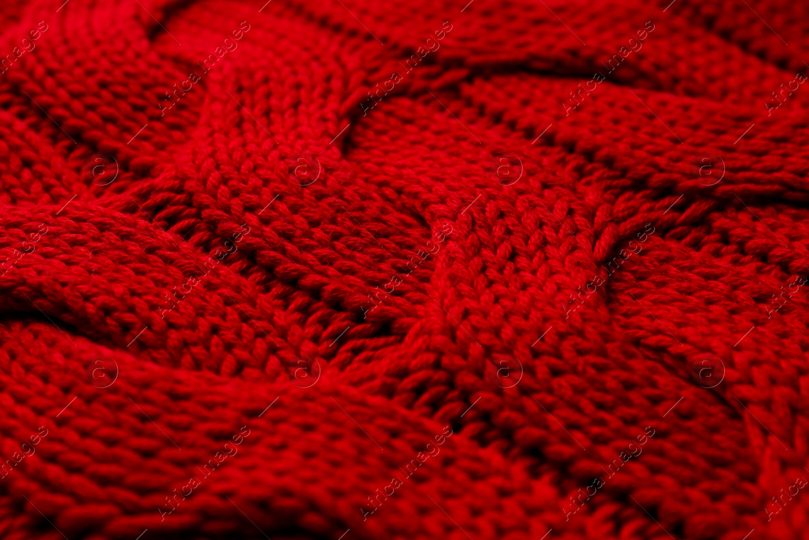 Photo of Beautiful red knitted fabric as background, closeup