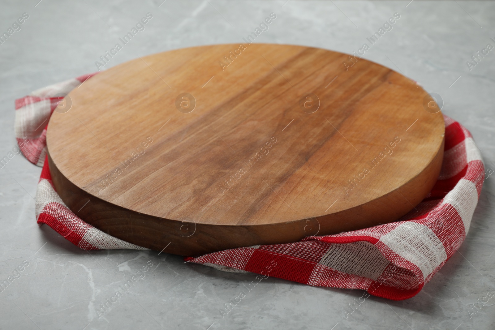 Photo of Wooden board and kitchen towel on grey stone table