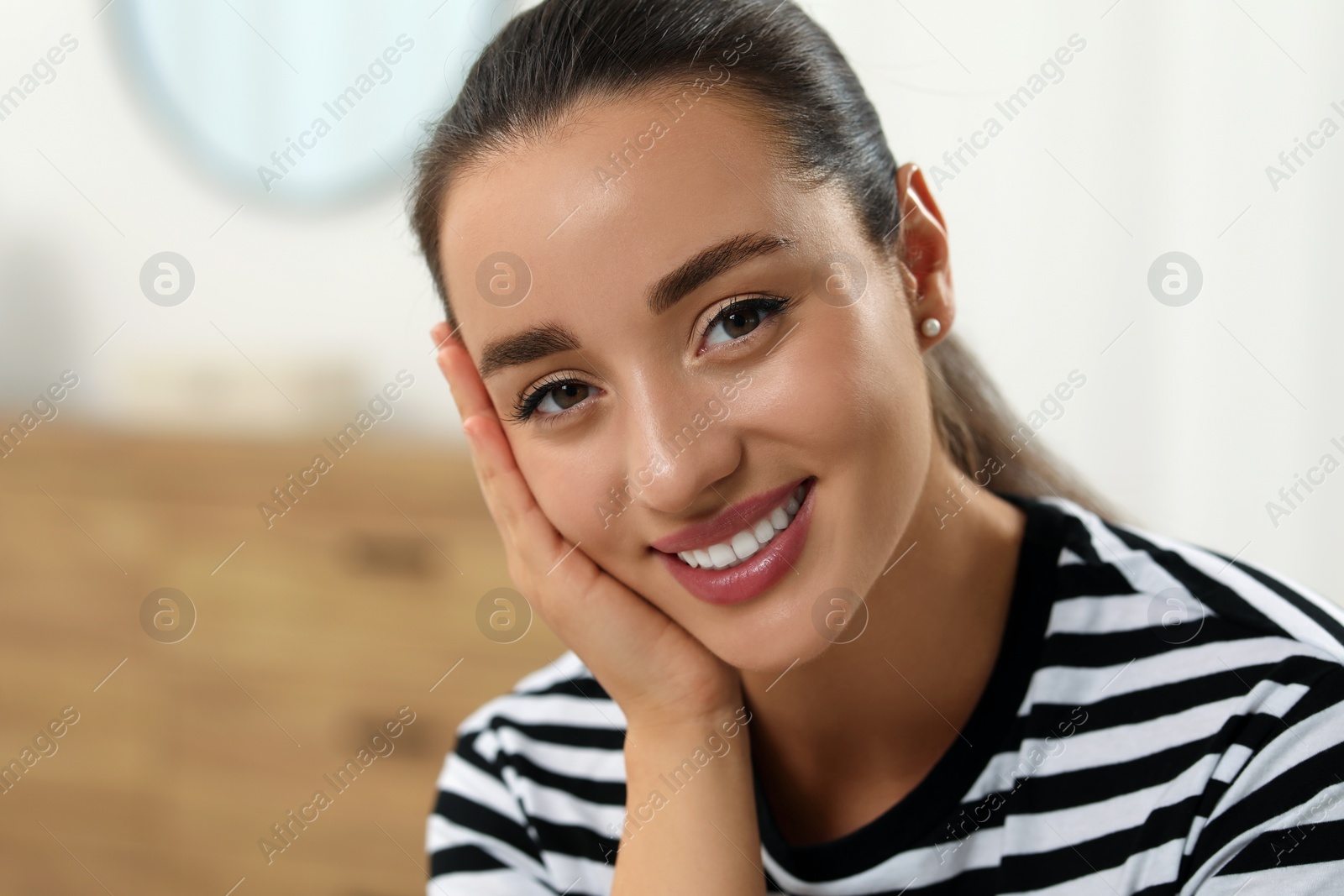 Photo of Portrait of beautiful young woman indoors, space for text. Attractive lady smiling and looking into camera