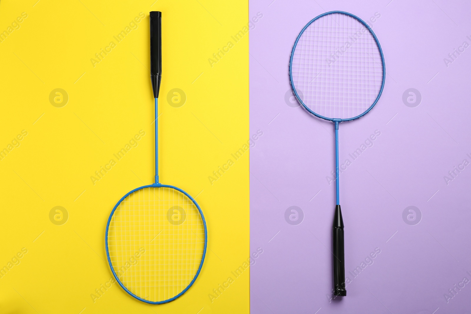 Photo of Rackets on color background, flat lay. Badminton equipment