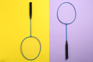 Photo of Rackets on color background, flat lay. Badminton equipment