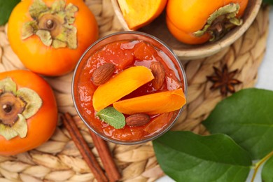 Photo of Delicious dessert with persimmon on table, flat lay