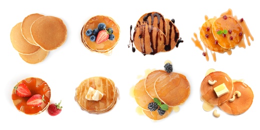 Image of Set of delicious pancakes with different toppings on white background, top view. Banner design 