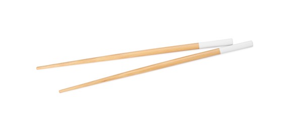 Photo of Pair of wooden chopsticks isolated on white, top view