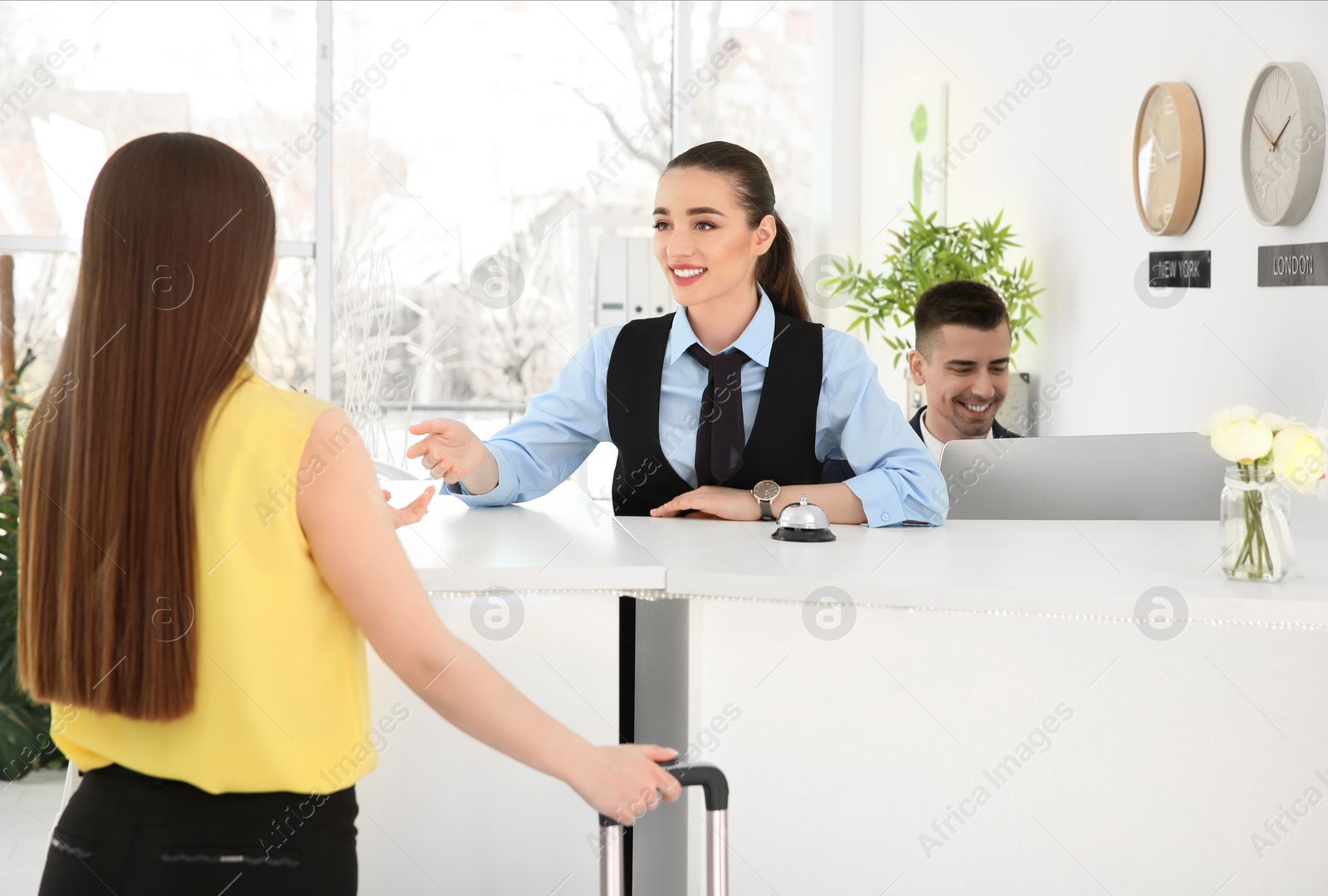 Photo of Young woman near reception desk in hotel