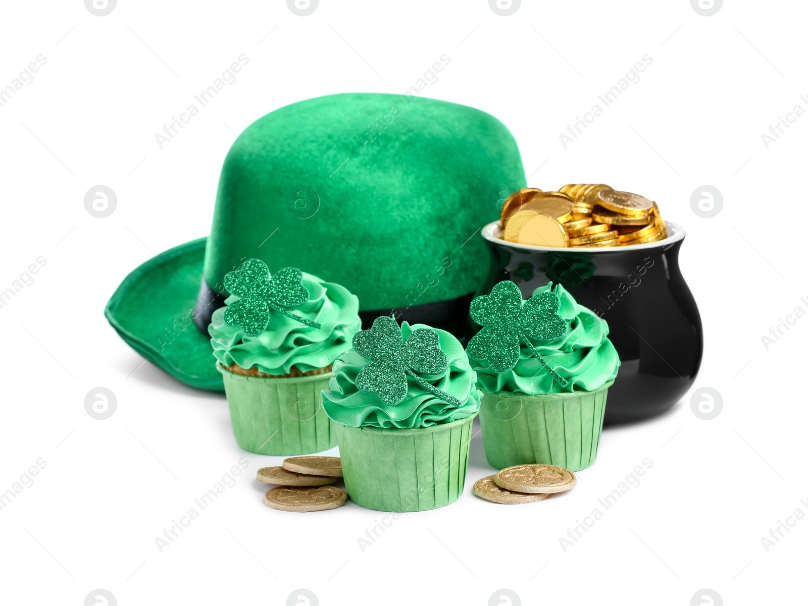 Photo of St. Patrick's day party. Tasty festively decorated cupcakes, green hat and pot of gold, isolated on white
