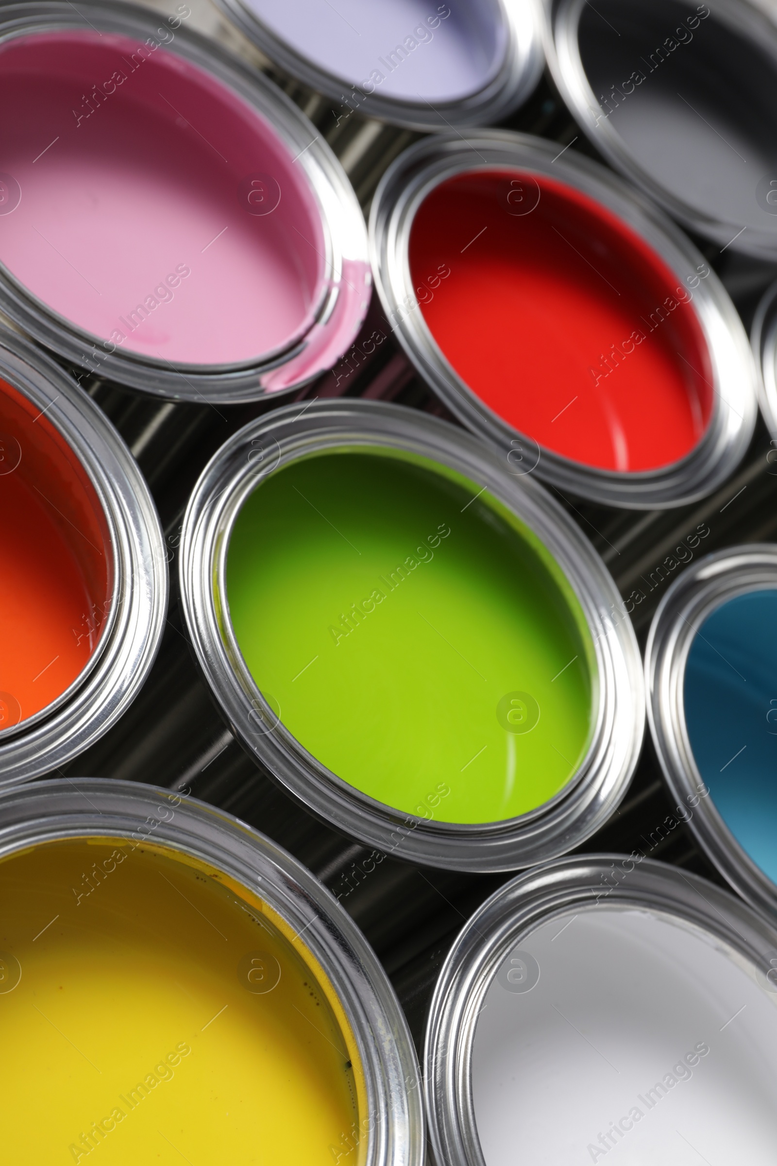 Photo of Cans of different colorful paints as background