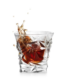 Photo of Glass of expensive whiskey with splash on white background