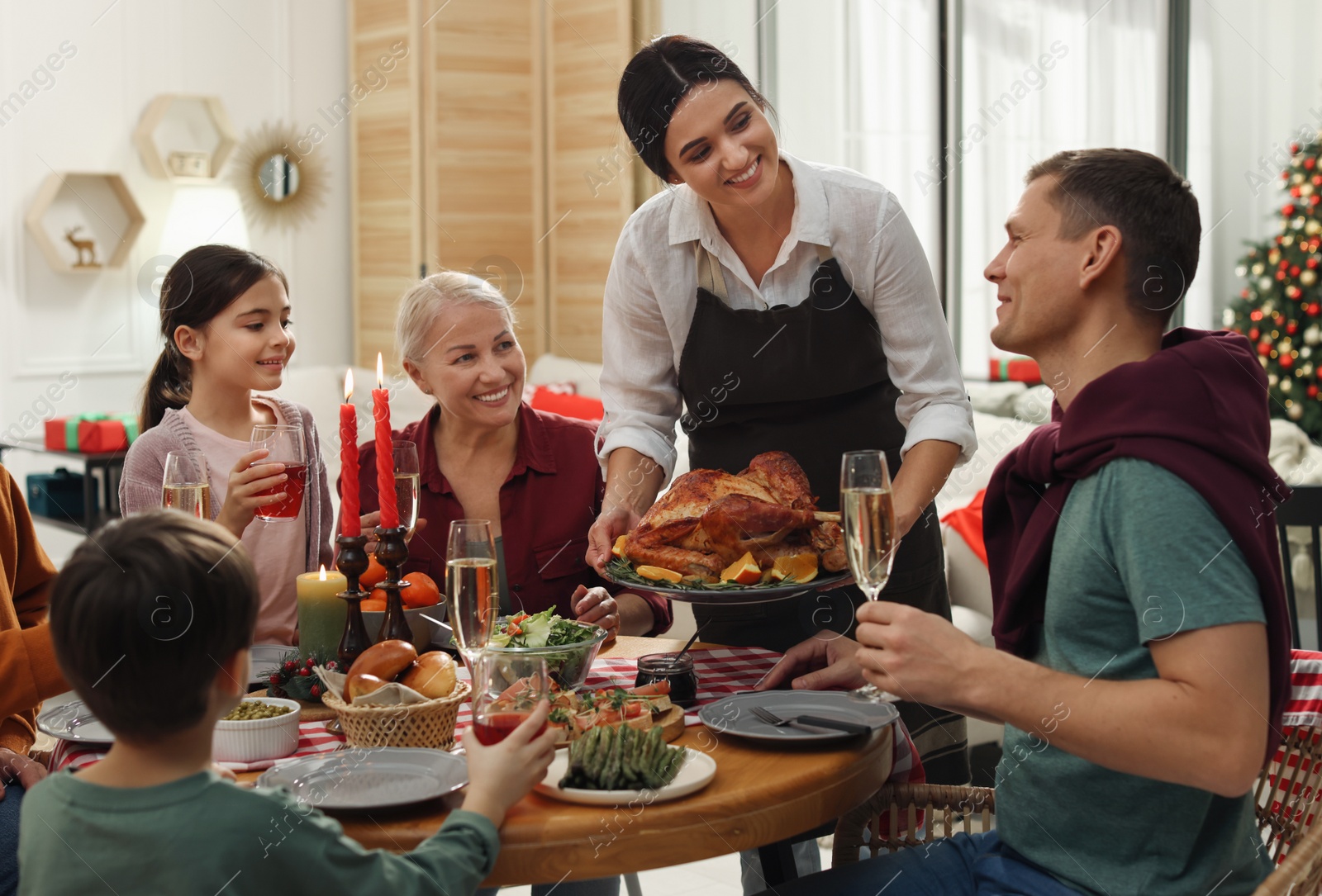 Photo of Happy family enjoying festive dinner at home. Christmas celebration