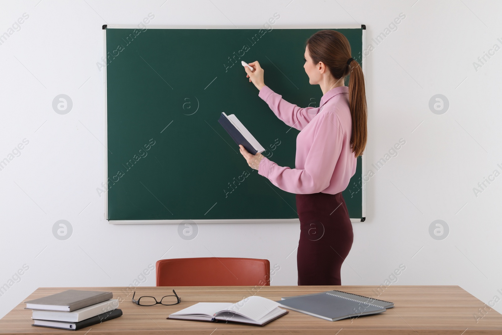 Photo of Portrait of young female teacher in classroom