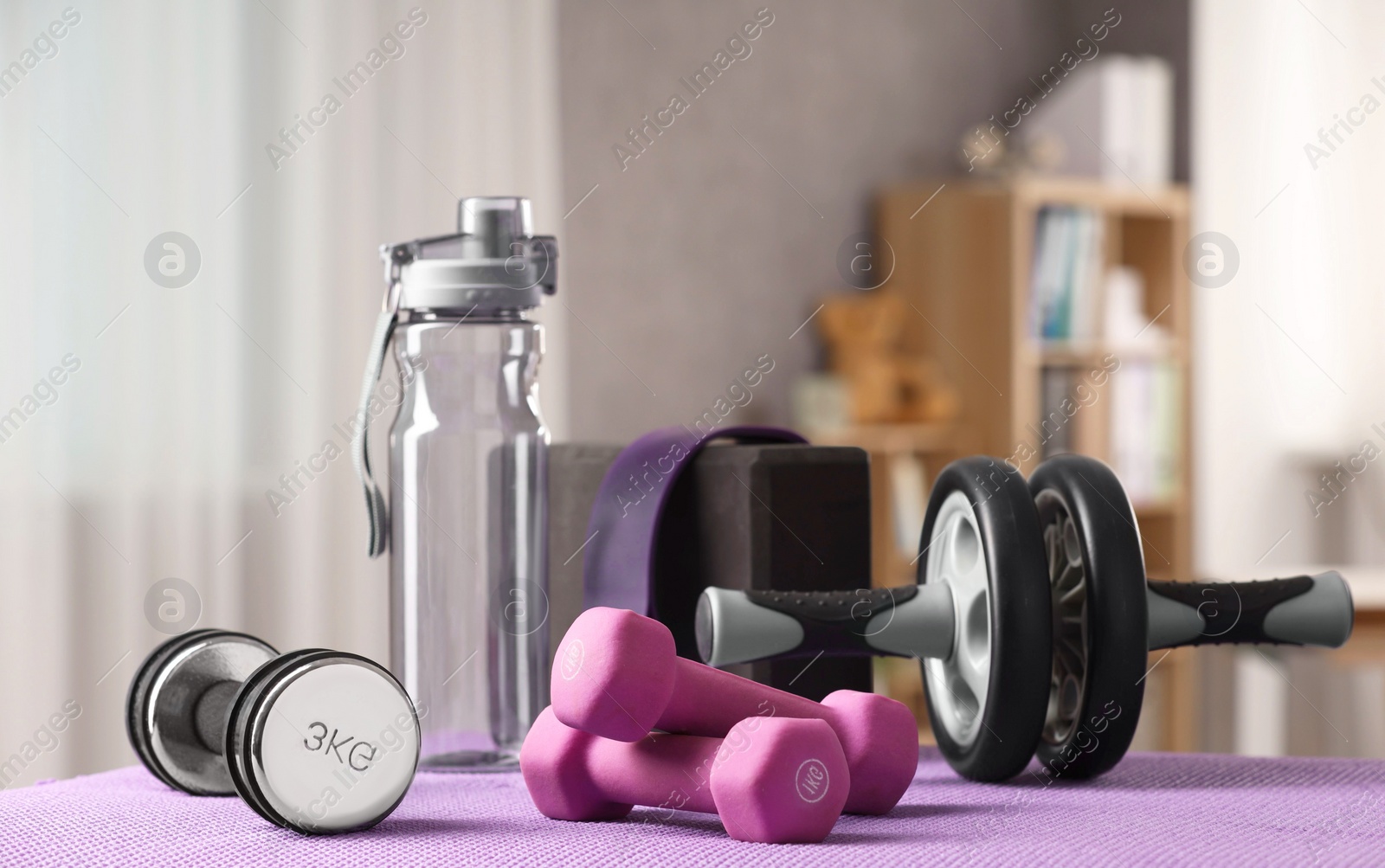 Photo of Many different sports equipment on mat indoors