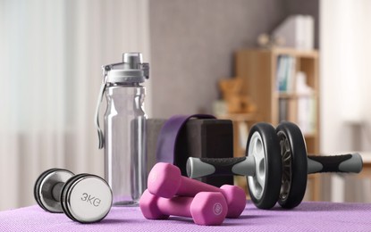 Photo of Many different sports equipment on mat indoors