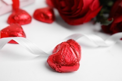 Tasty heart shaped chocolate candies on white background, closeup. Valentine's day celebration