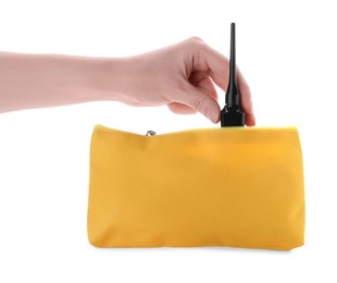 Photo of Woman taking out eyeliner from yellow cosmetic bag on white background, closeup