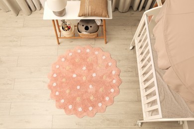 Photo of Baby room interior with modern furniture and soft rug, above view