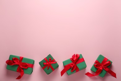 Photo of Bright gift boxes on pink background, flat lay. Space for text